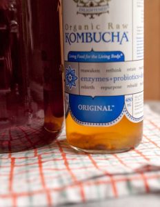 A blobby "baby scoby" forming in a bottle of store-bought kombucha - you can use this to make a new scoby! (Image credit: Emma Christensen)